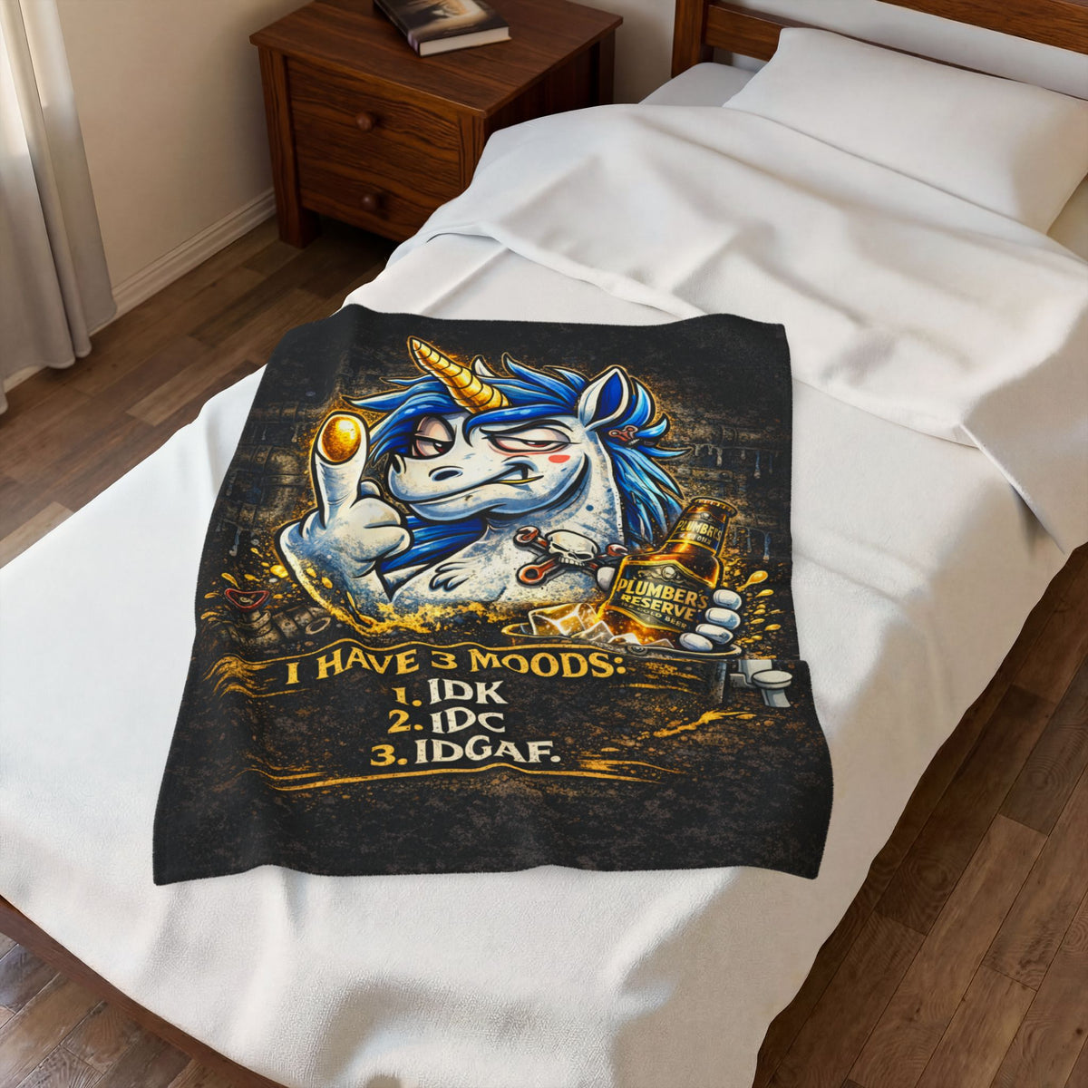 OutHouse Gen X 3 Moods plush blanket spread across a bed showing its printed design and coverage
